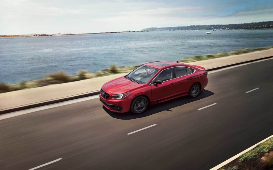 A red 2020 Subaru Legacy Sport cruising down the highway.