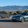 the BMW 3 series sedan and wagon parked on pavement with a scenic mountainous background