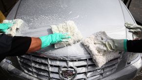 Workers detail a car