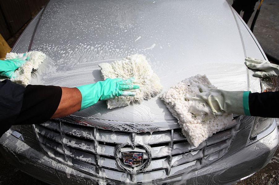 Workers detail a car