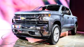 A blue Chevy Silverado on display at an auto show