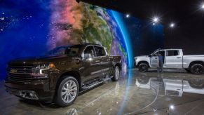 A man looks at a Chevrolet Silverado truck at the auto trade show, AutoMobility LA, at the Los Angeles Convention Center