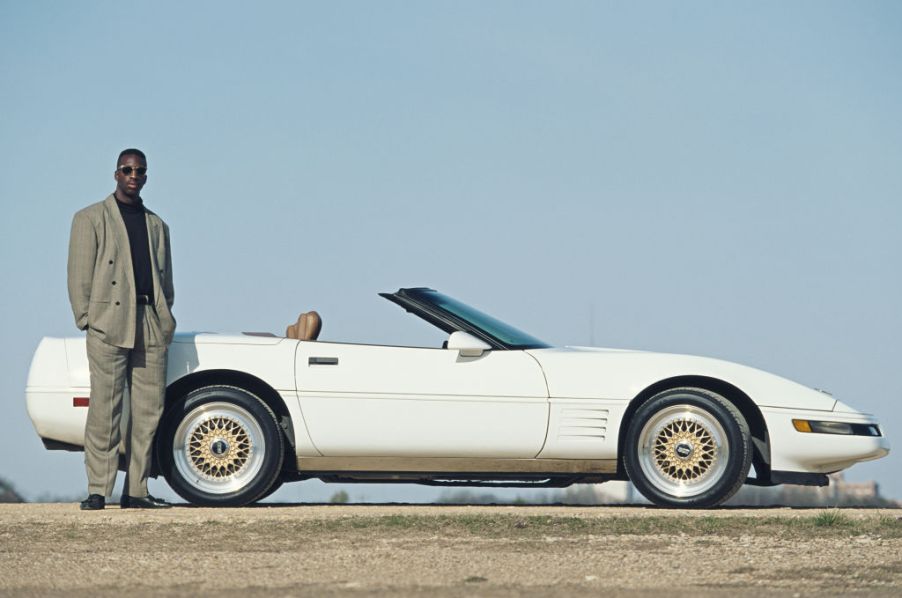 A portrait of Olympic and IAAF World Championship Gold medal wiinning 200 metres and 400 metres sprinter Michael Johnson of the United States standing alongside his Chevrolet Corvette C4 Coupe