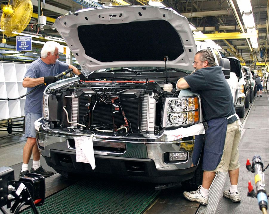 Workers assembling full-size trucks