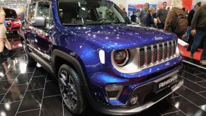 A blue Jeep Renegade on display at an auto show