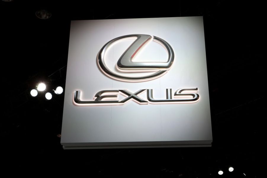 An illuminated Lexus sign at an auto show