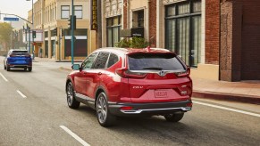 2020 Honda CR-V Hybrid in red driving on the road