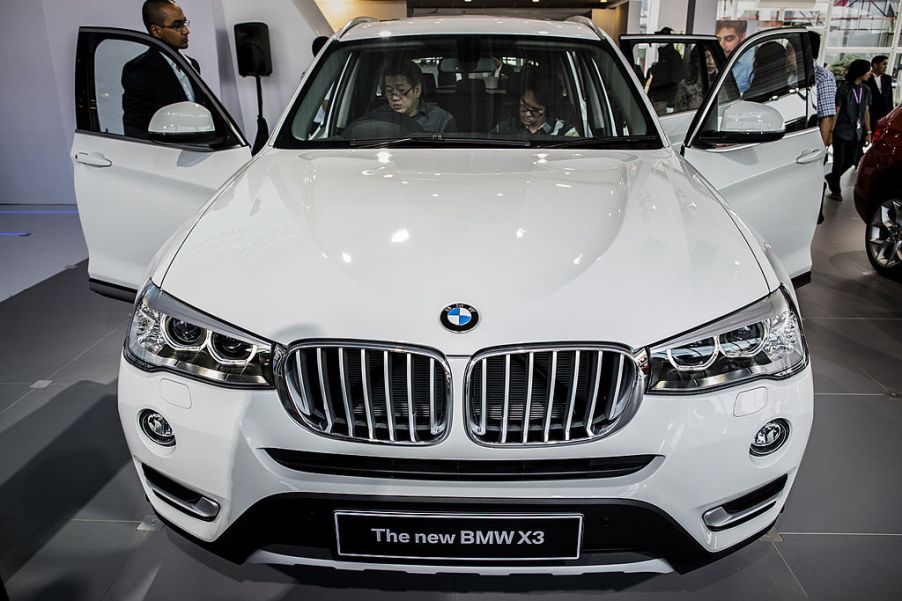 Visitors look inside the new BMW x3 at The 22st Indonesia International Motor Show