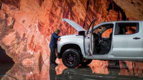 A man looks at a Chevrolet Silverado truck at the auto trade show, AutoMobility LA, at the Los Angeles Convention Center