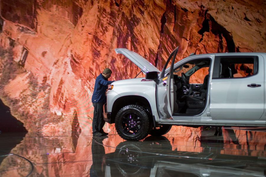 A man looks at a Chevrolet Silverado truck at the auto trade show, AutoMobility LA, at the Los Angeles Convention Center