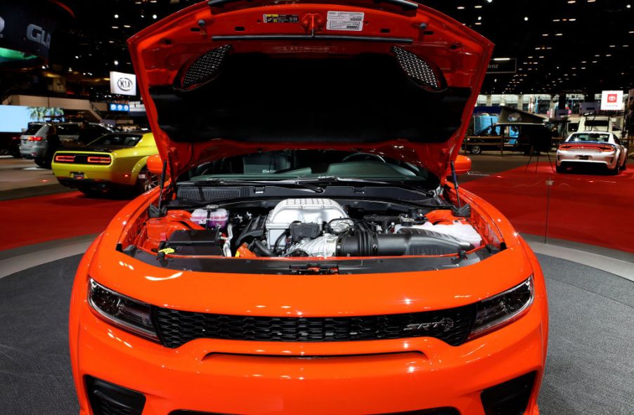 A 2020 Dodge Charger on display with its engine showing