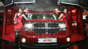 A Model poses next to a Dodge Nitro at the Seoul Motor Show 2007