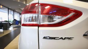 A rearview of a white Ford Escape SUV.