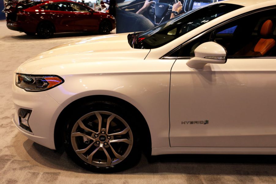 A white Ford Fusion on display at an auto show