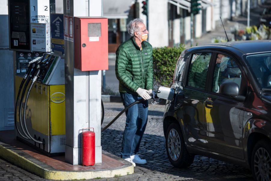 A man with mask makes gasoline from a gas station in Turin during on the Italy Extends Coronavirus Lockdown