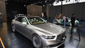 People look at a Hyundai Genesis G90 car during the 2nd China International Import Expo (CIIE) at the National Exhibition and Convention Center