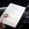 An International Driving Permit placed on top of a steering wheel.