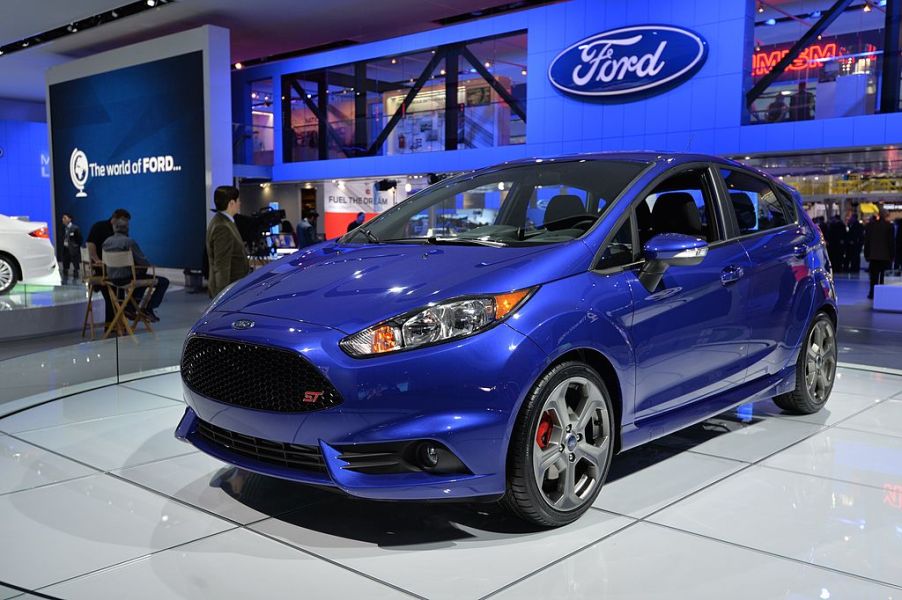 A blue first-generation Ford Fiesta ST displayed at an autoshow.