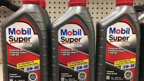 Quarts of motor oil displayed on a store shelf.