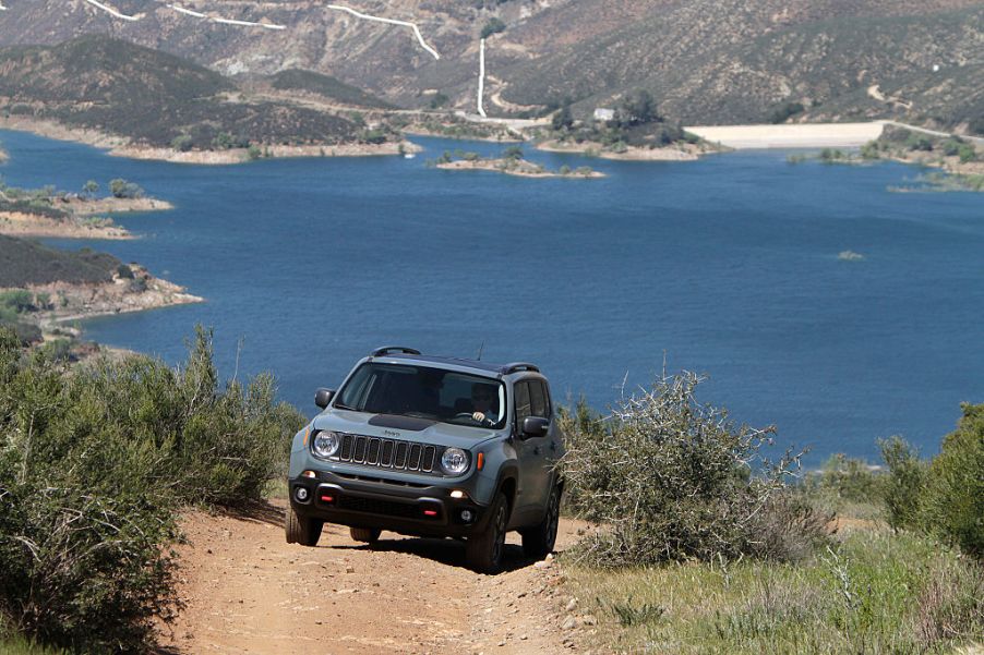 Jeep Renegade driving up dirt road near beach