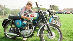 A child polishing a new motorcycle