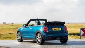 Mini Cooper Convertible parked near a beach