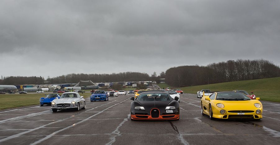 A group of supercars on parade, including a Bugatti, and Mercedes AMG 300SL built for the Sultan of Brunei