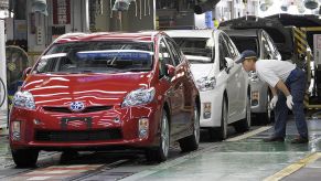 Workers assemble cars at a Toyota factory