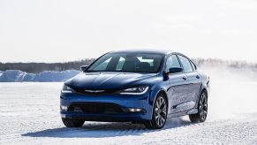 A blue 2015 Chrysler 200 AWD kicks up snow.