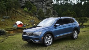 A blue 2020 Volkswagen Tiguan parked ion a grass lot.