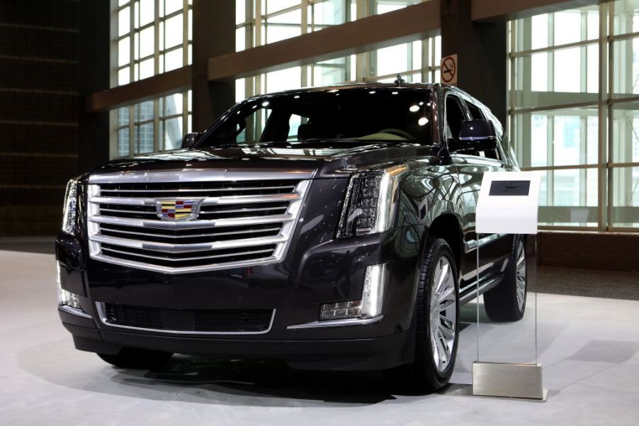 A black Cadillac Escalade on display at an auto show