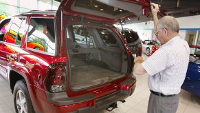 A man inspected a Chevy Trailblazer