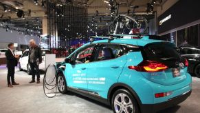 People look at a Chevrolet Bolt EV car during 2020 Canadian International Autoshow