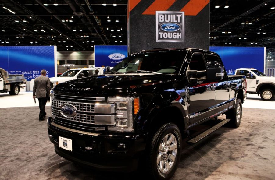 A black Ford F-250 on display at an auto show