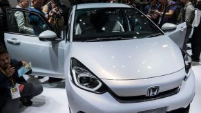 Members of the media look at Honda Motor Co.'s redesigned Fit compact vehicle during a press conference at the Tokyo Motor Show