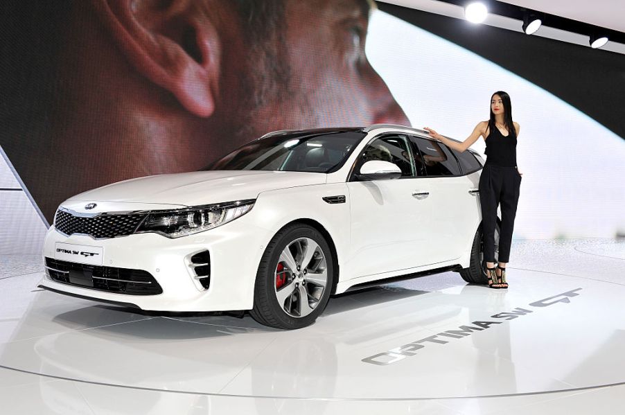 A model poses next to KIA Optima SW GT during the Geneva Motor Show 2016