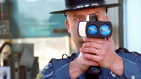 An officer and a handheld radar gun