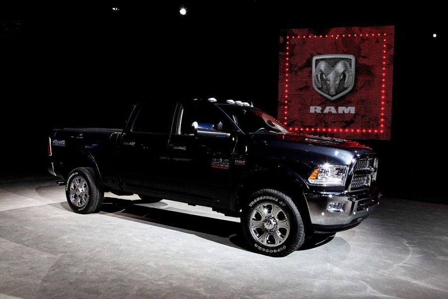 A black heavy duty Ram pickup truck on display at an auto show