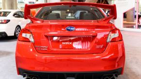 A red Subaru WRX STI on display at an auto show