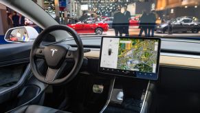 Tesla Model 3 compact full electric car interior with a large touch screen on the dashboard on display at Brussels Expo