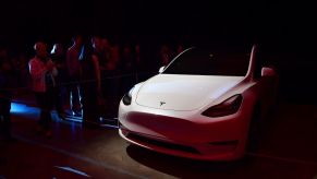 People view a model of the new Tesla Model Y unveiled earlier in Hawthorne, California