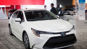 A 2020 Toyota Corolla Hybrid on display at an auto show