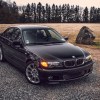 Black 2003 BMW E46 330i ZHP sedan parked on rocky road