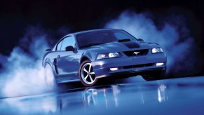 Blue 2003 Ford Mustang Mach 1 doing a burnout