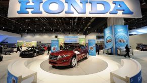 A red 2010 Honda Accord on display at an auto show