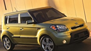 A bright green 2010 Kia Soul on the track.