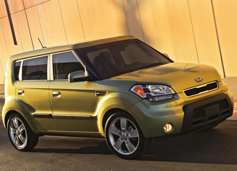 A bright green 2010 Kia Soul on the track.