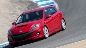 Red 2010 Mazdaspeed3 going around a corner