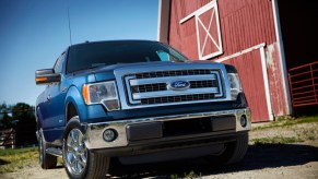 The 2014 Ford F-150 parked near a barn