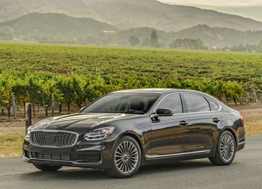 2020 Kia K900 driving down the countryside.